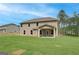 Backyard view of a new home with a spacious lawn and covered patio at 100 Bre Dr, Fayetteville, GA 30214