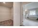 Bathroom with soaking tub is seen from closet with wire shelves at 100 Bre Dr, Fayetteville, GA 30214