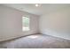 This is a large bedroom with gray carpet and a window view at 100 Bre Dr, Fayetteville, GA 30214