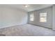This is a large bedroom with gray carpet and two windows with great views at 100 Bre Dr, Fayetteville, GA 30214