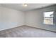 This is a large bedroom with gray carpet and a single window view at 100 Bre Dr, Fayetteville, GA 30214