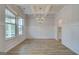 Dining room featuring modern wood floors, decorative wainscoting, complementary paint, and a modern chandelier at 100 Bre Dr, Fayetteville, GA 30214