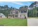 Inviting two-story home featuring a well-manicured lawn, neutral color scheme, and complementary landscaping at 100 Bre Dr, Fayetteville, GA 30214