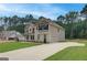 Charming two-story home with a two-car garage, long driveway, manicured lawn, and established landscaping at 100 Bre Dr, Fayetteville, GA 30214