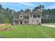Inviting two-story home featuring a well-manicured lawn, neutral color scheme, and complementary landscaping at 100 Bre Dr, Fayetteville, GA 30214