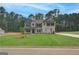 Inviting two-story home featuring a well-manicured lawn, neutral color scheme, and complementary landscaping at 100 Bre Dr, Fayetteville, GA 30214