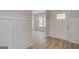 Bright entryway featuring beautiful wood-look floors, wainscoting, and a freshly painted color scheme at 100 Bre Dr, Fayetteville, GA 30214