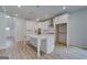 Bright kitchen boasts white cabinetry, stainless appliances, stone countertops and a large center island at 100 Bre Dr, Fayetteville, GA 30214