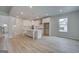 Open-concept living space showcases sleek floors, abundant natural light, and a modern kitchen with an island at 100 Bre Dr, Fayetteville, GA 30214