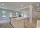 Bright living space boasts sleek floors, recessed lighting, and an island with a stainless steel sink at 100 Bre Dr, Fayetteville, GA 30214