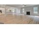 Bright open-concept living space features sleek floors, abundant natural light, and a fireplace at 100 Bre Dr, Fayetteville, GA 30214
