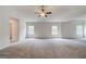 Large main bedroom with gray carpet, ceiling fan and natural light from the windows at 100 Bre Dr, Fayetteville, GA 30214