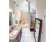 Bright bathroom featuring a granite countertop, soaking tub with a window, and a tiled shower at 508 Caxton Ct, Peachtree City, GA 30269
