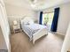 Cozy bedroom featuring a window with curtains, white bed, and carpeted flooring at 508 Caxton Ct, Peachtree City, GA 30269