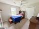 Comfortable carpeted bedroom featuring a ceiling fan, closet, and window with natural light at 508 Caxton Ct, Peachtree City, GA 30269