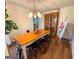 Open dining room featuring hardwood floors and an artful antique cabinet at 508 Caxton Ct, Peachtree City, GA 30269