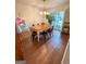 Dining room with hardwood floors, large windows, and unique stained-glass accent at 508 Caxton Ct, Peachtree City, GA 30269