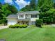 Charming two-story home boasts a well-manicured lawn, a welcoming porch, and lush greenery, creating delightful curb appeal at 508 Caxton Ct, Peachtree City, GA 30269
