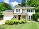 Charming two-story home featuring a manicured lawn, a welcoming porch, and lush greenery, offering inviting curb appeal at 508 Caxton Ct, Peachtree City, GA 30269