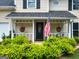 Inviting front porch with charming hanging baskets and a view of the manicured front yard landscaping at 508 Caxton Ct, Peachtree City, GA 30269