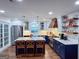 Elegant kitchen featuring navy-blue and white cabinetry, a large island with seating, and modern stainless steel appliances at 508 Caxton Ct, Peachtree City, GA 30269