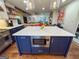 Bright kitchen featuring a navy island, quartz countertops, and stainless steel appliances at 508 Caxton Ct, Peachtree City, GA 30269