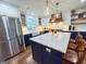 Modern kitchen featuring a large island with seating, white countertops, and stainless steel appliances, perfect for cooking and entertaining at 508 Caxton Ct, Peachtree City, GA 30269