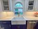 Farmhouse sink with designer faucet offering a view of the backyard garden at 508 Caxton Ct, Peachtree City, GA 30269