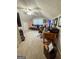 A versatile carpeted living room or office space with a desk and leather couch at 508 Caxton Ct, Peachtree City, GA 30269