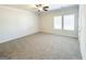 Spacious bedroom featuring a ceiling fan, two windows, carpet flooring and a neutral color palette at 5096 Cumberland Ct # 96, Villa Rica, GA 30180