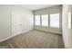 Cozy bedroom with neutral carpet, multiple windows, and a closet door at 5096 Cumberland Ct # 96, Villa Rica, GA 30180