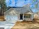 Charming single-Gathering home featuring a two-car garage, dark grey roof, and an inviting front porch at 5096 Cumberland Ct # 96, Villa Rica, GA 30180