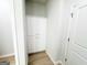Hallway with white cabinets, neutral color scheme, and modern flooring connecting rooms creating a cohesive and stylish look at 5096 Cumberland Ct # 96, Villa Rica, GA 30180