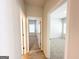 Hallway featuring doorways to carpeted bedrooms with natural light, showcasing layout at 5096 Cumberland Ct # 96, Villa Rica, GA 30180