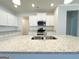 Modern kitchen features stainless steel appliances, granite countertops, and white cabinetry at 5096 Cumberland Ct # 96, Villa Rica, GA 30180