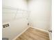 Functional laundry room with shelving for storage and wood flooring at 5096 Cumberland Ct # 96, Villa Rica, GA 30180