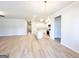 Open concept living area featuring an electric fireplace, wood floors, and pendant lighting at 5096 Cumberland Ct # 96, Villa Rica, GA 30180