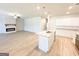 Open concept living area featuring an electric fireplace, wood floors, and pendant lighting at 5096 Cumberland Ct # 96, Villa Rica, GA 30180