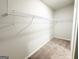 This is a carpeted walk-in closet with shelving for optimal organization at 5096 Cumberland Ct # 96, Villa Rica, GA 30180