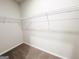 A well-organized walk-in closet with sturdy shelving, providing ample storage for clothing and accessories at 5096 Cumberland Ct # 96, Villa Rica, GA 30180
