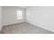 Bright bedroom with plush carpeting and neutral walls creates a serene space at 260 Oliver Dr, Locust Grove, GA 30248