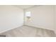 Bedroom with neutral walls and carpet flooring, featuring a window with a neighborhood view at 260 Oliver Dr, Locust Grove, GA 30248