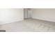 A spacious bedroom boasts neutral walls, plush carpeting, and an open doorway at 260 Oliver Dr, Locust Grove, GA 30248