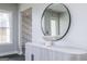 Bright entryway with a round mirror, gray console table, and view of a room with patterned wallpaper at 260 Oliver Dr, Locust Grove, GA 30248