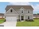 Charming two-story home featuring a manicured lawn and attached two-car garage at 260 Oliver Dr, Locust Grove, GA 30248