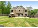 Beautiful backyard showcasing a patio with outdoor seating and a well-maintained lawn at 150 Rockspray Rdg, Peachtree City, GA 30269
