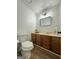 Cozy bathroom featuring wood floors, a mirror, and a toilet at 150 Rockspray Rdg, Peachtree City, GA 30269