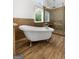 Bright bathroom showcasing a soaking tub, glass shower, and natural light from the large window at 150 Rockspray Rdg, Peachtree City, GA 30269