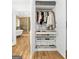 Open closet with organizers and storage leading to a bathroom with soaking tub and shower at 150 Rockspray Rdg, Peachtree City, GA 30269