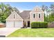 Charming two-story home featuring a well-manicured lawn and a two-car garage at 150 Rockspray Rdg, Peachtree City, GA 30269